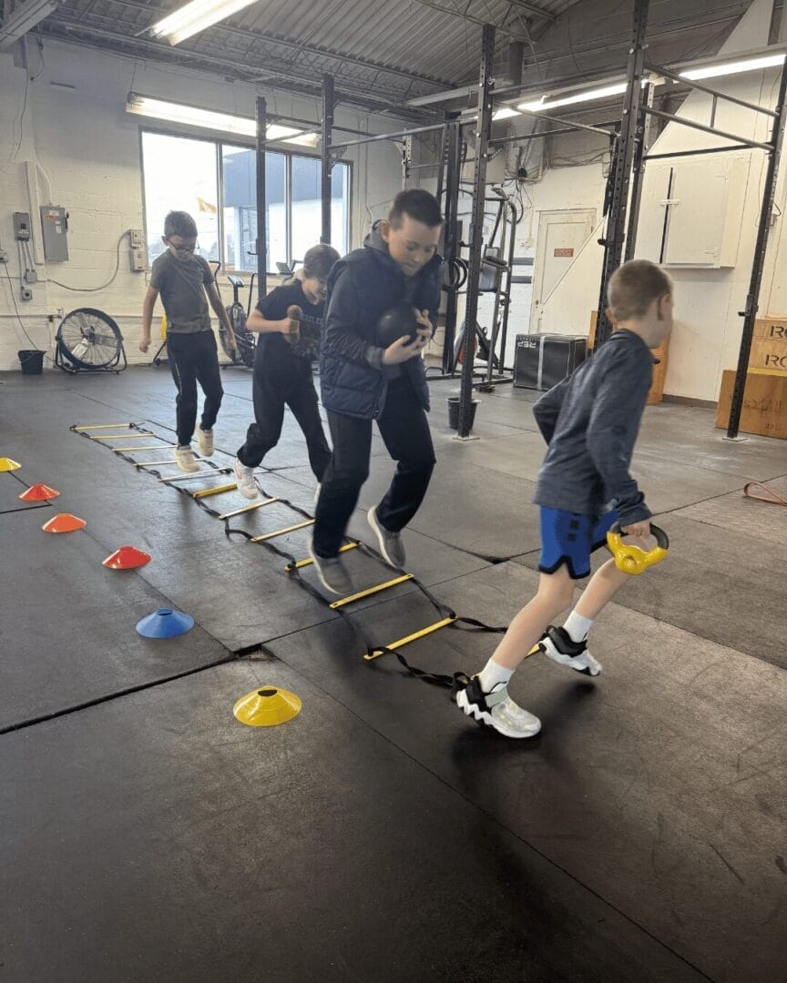 Kids ages 7-12 learning loaded footwork with coach at The Well Health and Fitness in Bowling Green Ohio