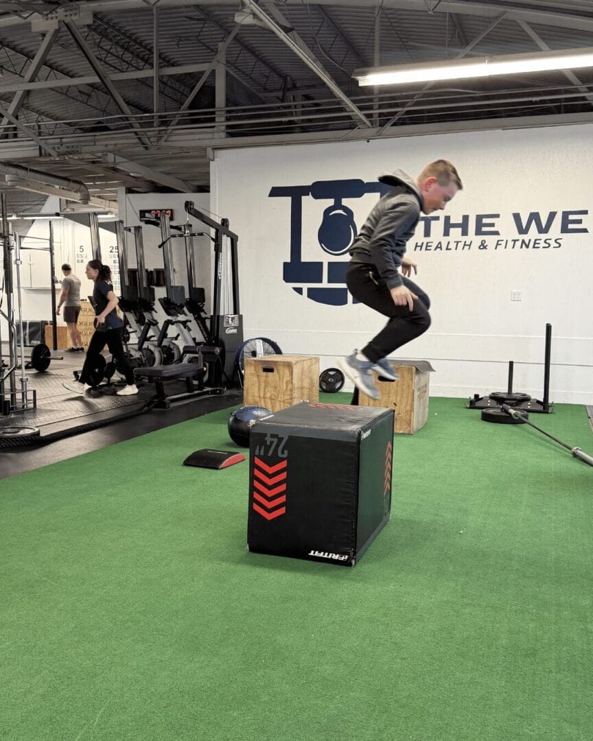 Middle school student completing box jumps in youth fitness class at Bowling Green gym The Well